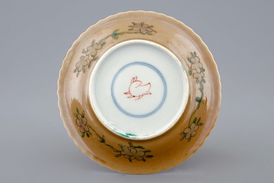 A Chinese famille verte and caf&eacute; au lait cup and saucer, Kangxi